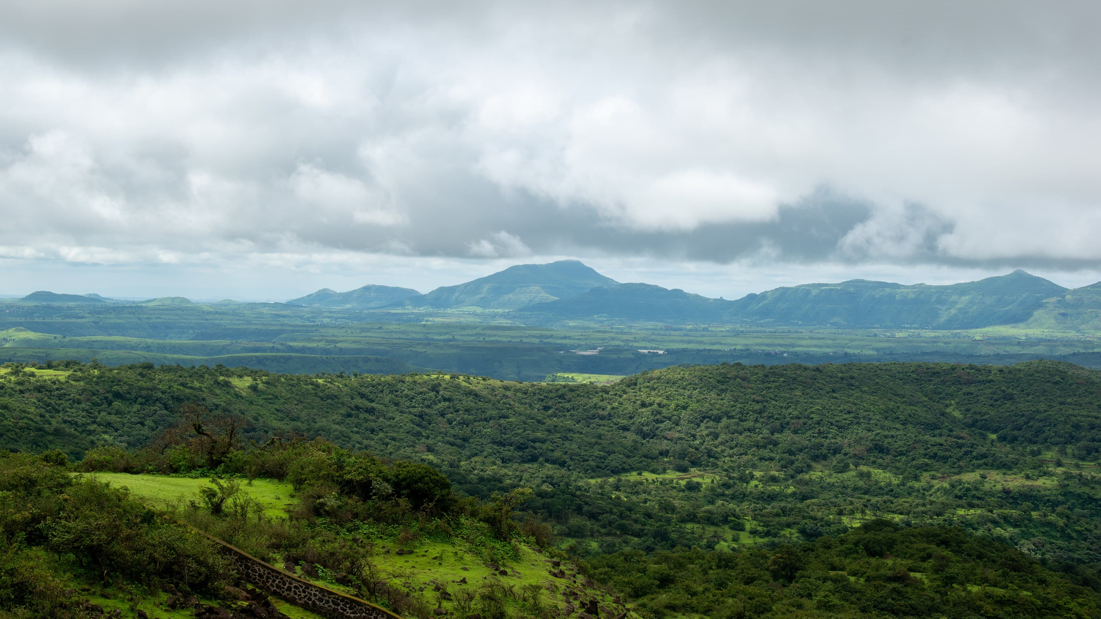 Forested Sahyadri hills under monsoon cloud